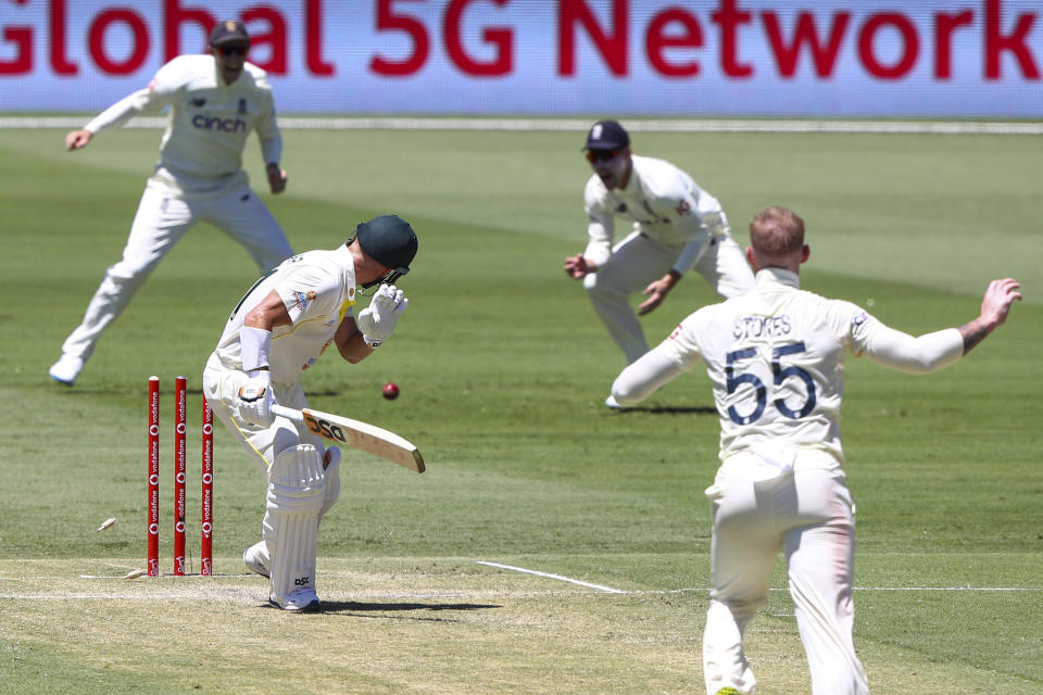 Australia's David Warner is bowled off a no ball by England's Ben Stokes, right, during day two of the first Ashes cricket test at the Gabba in Brisbane, Australia, Thursday, Dec. 9, 2021. (AP Photo/Tertius Pickard)