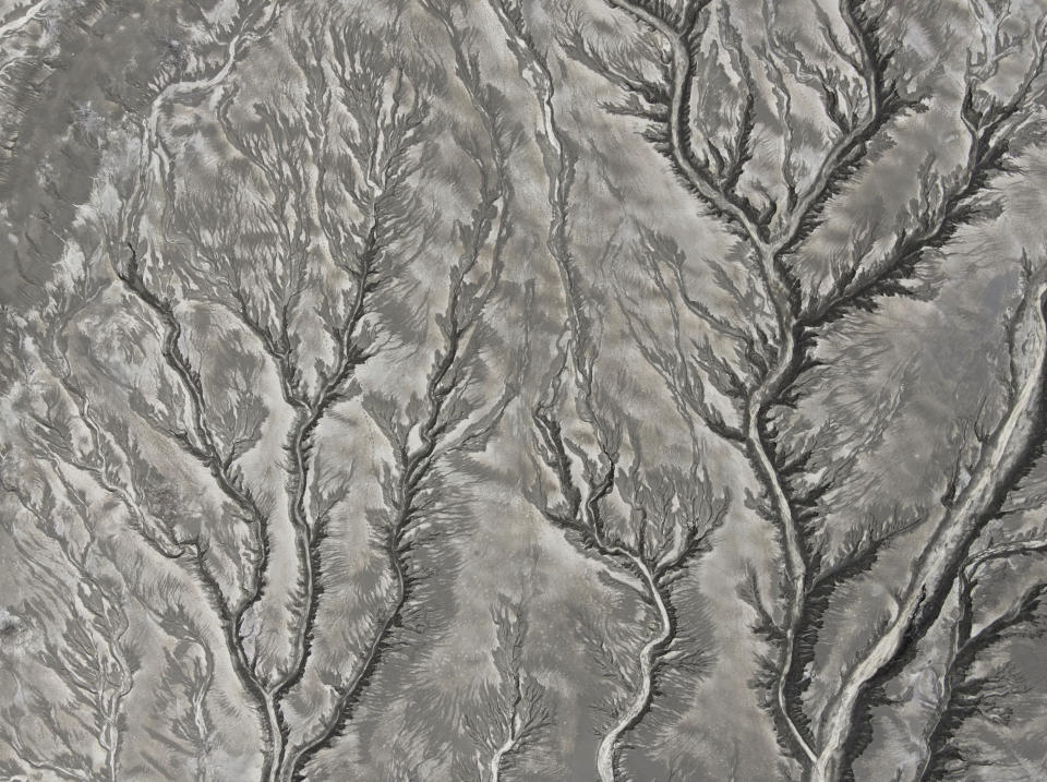 Patterns of erosion on volcanic ash deposits are seen at the Taal volcano almost a year after it erupted on Sunday, Jan. 10, 2021 in Batangas province, Philippines. A popular tourist destination just south of Manila because of its picturesque setting in the middle of a lake, Taal erupted on Jan. 12, 2020. The eruption displaced thousands of villagers living near the area and delivered an early crisis this year for one of the world's most disaster-prone nations a couple of months before the COVID-19 pandemic broke in the country. (AP Photo/Aaron Favila)