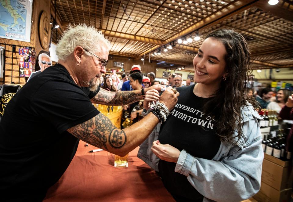 Celebrity restaurateur and television personality Guy Fieri signs the shirt of Maggie Sperdutti-Matesevac of Cos Cob, Conn., as Fieri made an appearance in the liquor department at Stew Leonards supermarket in Yonkers May 5, 2024. Fieri was on hand to promote his new tequila, named Santo Tequila. Members of the Yonkers fire and police departments and about two-hundred fans showed up to have their photos taken with Fieri and have him sign bottles of his tequila.