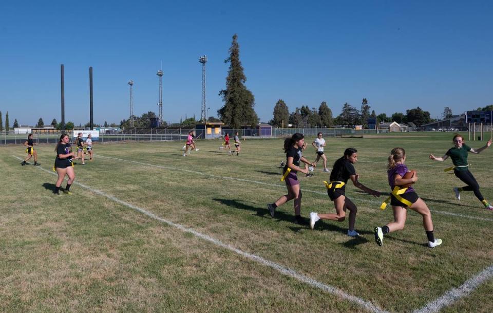 Girls practice flag football at Escalon High School in Escalon, Calif., Thursday, August 3, 2023.