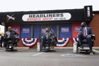 Democratic vice presidential candidate Sen. Kamala Harris, D-Calif., speaks as Reverend Wendell Anthony, left, and Michigan Lt. Gov. Garlin Gilchrist II listen at Headliners Barbershop in Detroit, Tuesday, Sept. 22, 2020. (AP Photo/Paul Sancya)