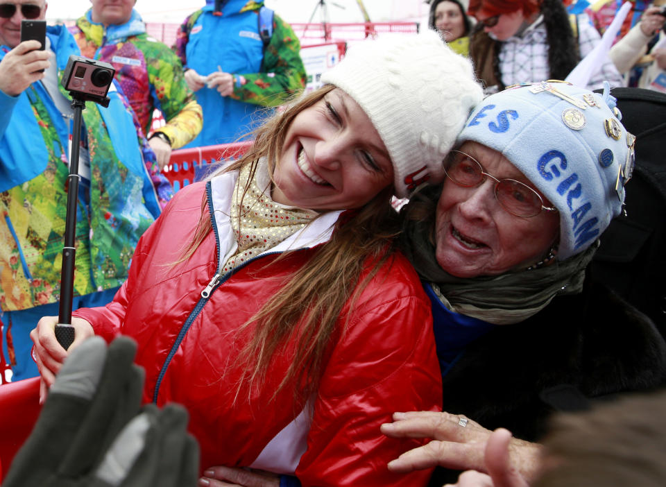 Women's supercombined bronze medal winner United States' Julia Mancuso and her grandmother Sheila Tuffanelli are surrounded by well-wishers at the Alpine ski venue at the Sochi 2014 Winter Olympics, Monday, Feb. 10, 2014, in Krasnaya Polyana, Russia. (AP Photo/Gero Breloer)