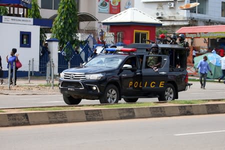 A police vehicle drives along Banex road after dispersing members of the IMN from the street in Abuja