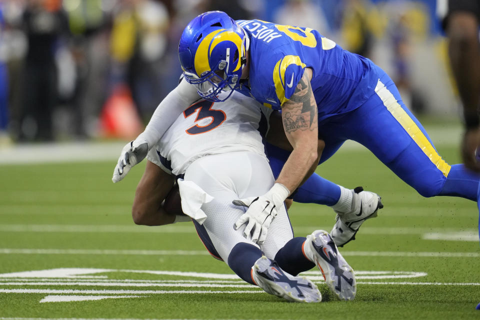 Los Angeles Rams defensive tackle Michael Hoecht sacks Denver Broncos quarterback Russell Wilson during the second half of an NFL football game between the Los Angeles Rams and the Denver Broncos on Sunday, Dec. 25, 2022, in Inglewood, Calif. (AP Photo/Marcio J. Sanchez)