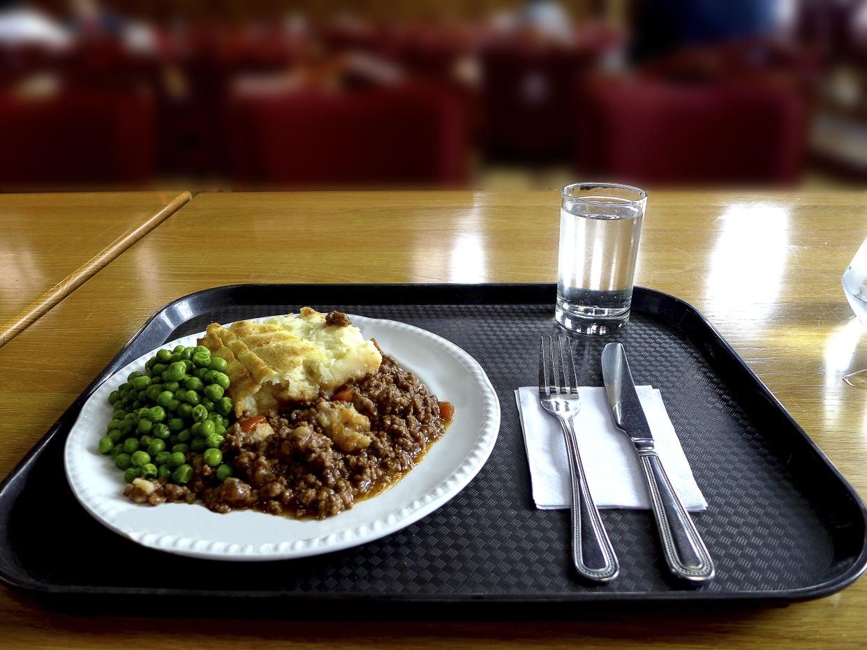 Shepherd’s Pie on a white plate on a black tray on a wooden table