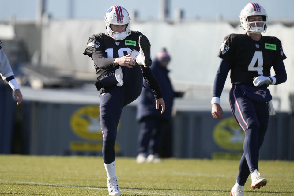 New England Patriots quarterbacks Mac Jones (10) and Bailey Zappe (4) warm up during an NFL football practice, Wednesday, Nov. 29, 2023, in Foxborough, Mass. (AP Photo/Steven Senne)