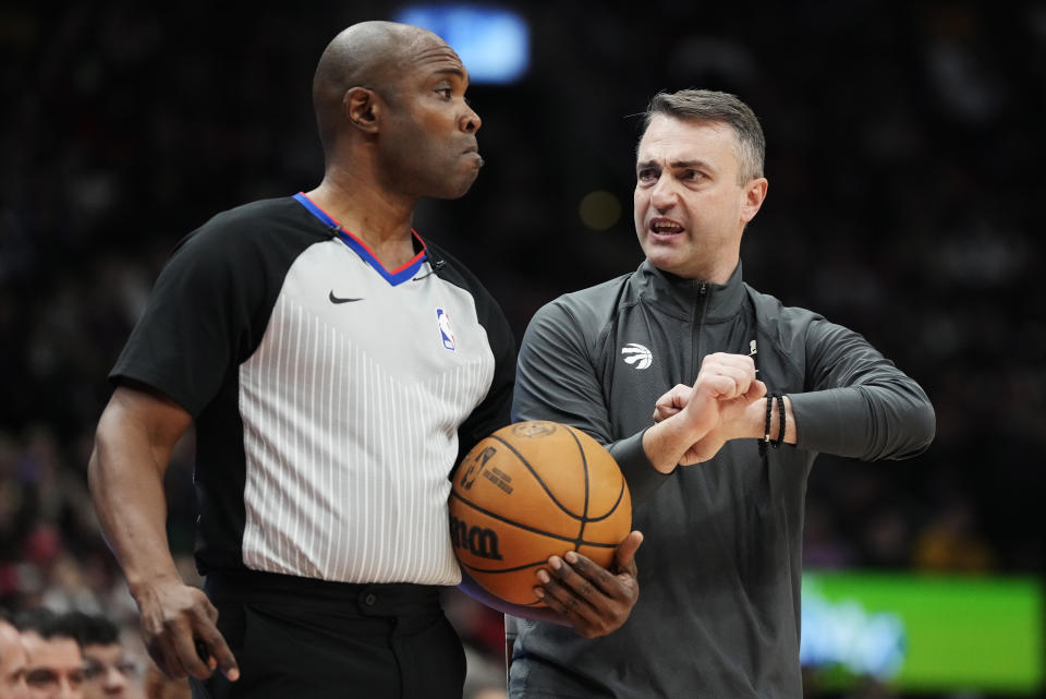 Toronto Raptors coach Darko Rajakovic speaks with referee Courtney Kirkland during the first half of the team's NBA basketball game against the Houston Rockets on Friday, Feb. 9, 2024, in Toronto. (Frank Gunn/The Canadian Press via AP)