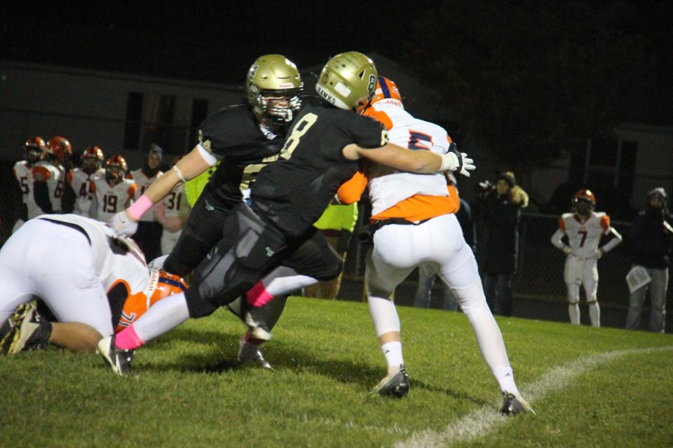 Woodward-Granger's Jalen Trudeau works to bring down Manson-NW Webster's Logan Moline on Friday, Oct. 14, 2022, at Hawk Stadium in Woodward.