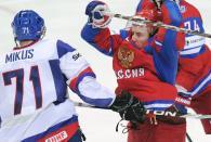 Russia's Yevgeni Ryasensky (R) vies with Slovakia's Juraj Mikus during the final game of the IIHF International Ice Hockey World Championship in Helsinki on May 20, 2012. AFP PHOTO/ ALEXANDER NEMENOVALEXANDER NEMENOV/AFP/GettyImages