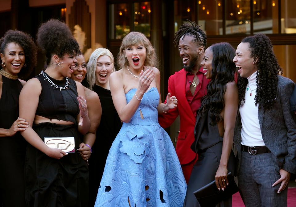 Taylor Swift (center) and her Eras Tour dancers, band members and backup singers arrive at the world premiere of the concert film "Taylor Swift: The Eras Tour" on Oct. 11, 2023, at The Grove in Los Angeles.