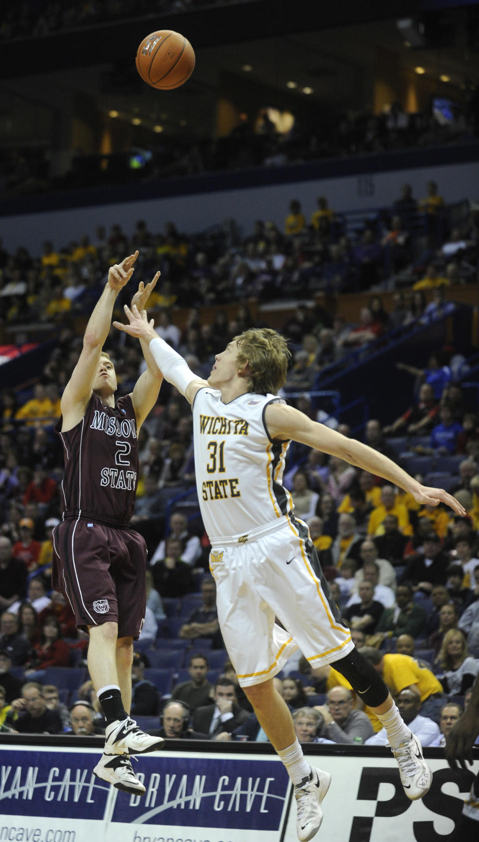 Missouri State's Austin Ruder (2) shoots over Wichita State's Ron Baker (31) in the first half of an NCAA college basketball game in the semifinals of the Missouri Valley Conference men's tournament, Saturday, March 8, 2014, in St. Louis. (AP Photo/Bill Boyce)