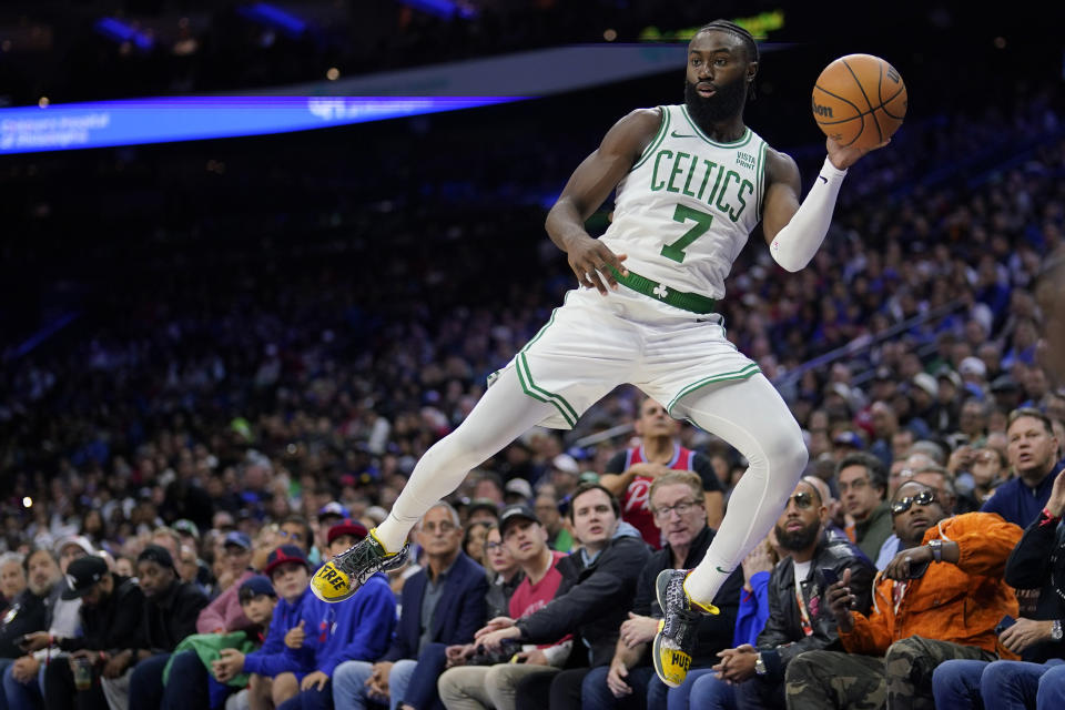 Boston Celtics' Jaylen Brown saves a loose ball during the second half of an NBA basketball game against the Philadelphia 76ers, Wednesday, Nov. 8, 2023, in Philadelphia. (AP Photo/Matt Slocum)