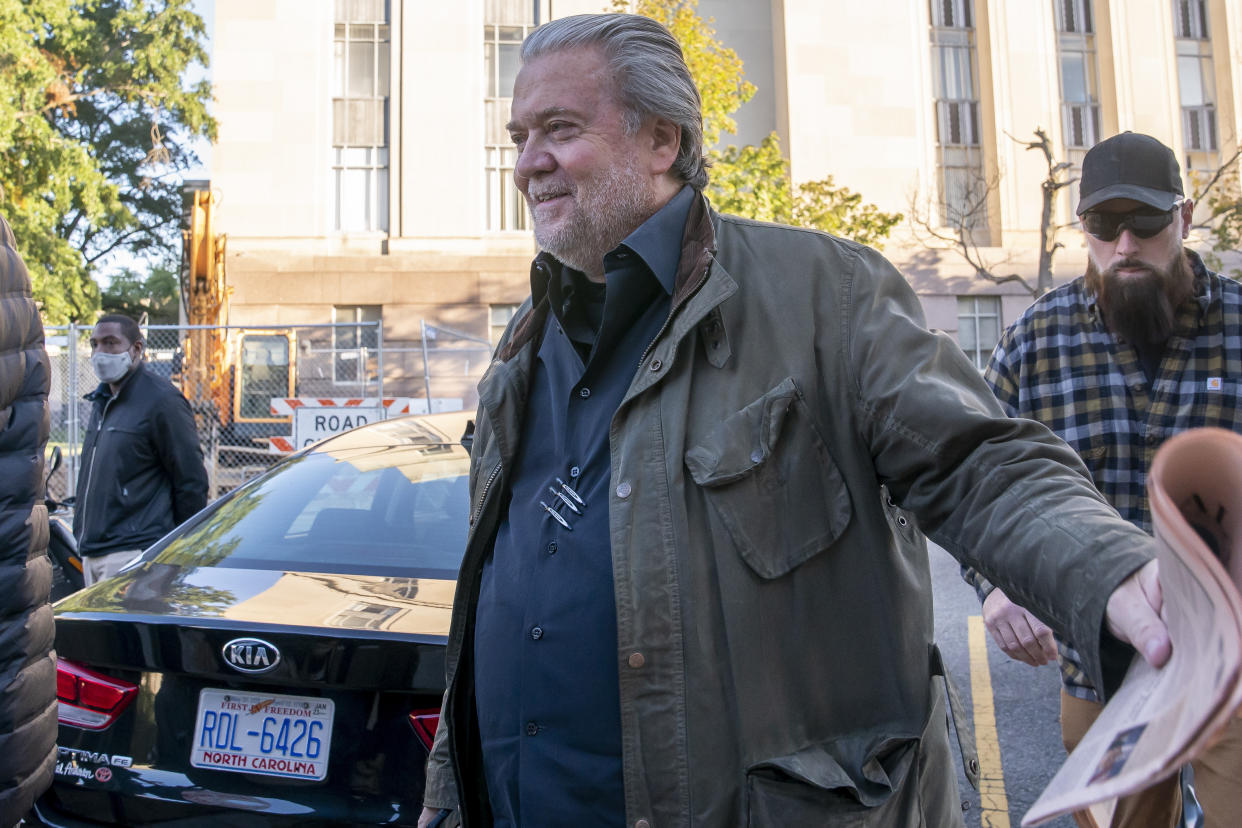 Steve Bannon, center, a longtime ally of former President Donald Trump, convicted of contempt of Congress, arrives at federal court for a sentencing hearing, Friday, Oct. 21, 2022, in Washington. (AP Photo/Nathan Howard)