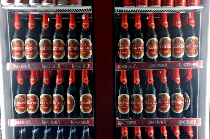 Kingfisher beer bottles are seen in a cooler at a liquor shop in Kolkata