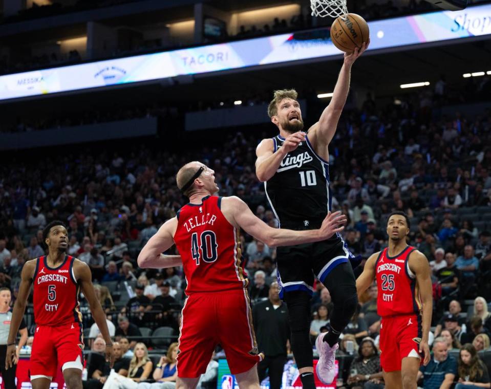 Sacramento Kings forward Domantas Sabonis (10) drives to the basket against New Orleans Pelicans center Cody Zeller (40) during a game at Golden 1 Center on Thursday.