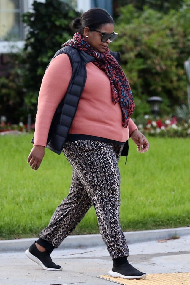 Abby Champion sports a white hoodie and black leggings during a power walk  in Brentwood, California