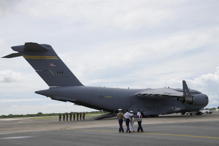 U.S. military carry the possible remains of a WWII U.S. airman found in northern Thailand to a waiting C-17 during a repatriation ceremony Wednesday, May 18, 2022, at the U-Tapao Air Base in Rayong province, eastern Thailand. The possible human remains were found at a crash site in a rice field in northern Thailand by the Defense POW/MIA Accounting Agency and were sent to Hawaii where they will be tested to see if they belong to a U.S. pilot who went missing in 1944. (AP Photo/Sakchai Lalit)