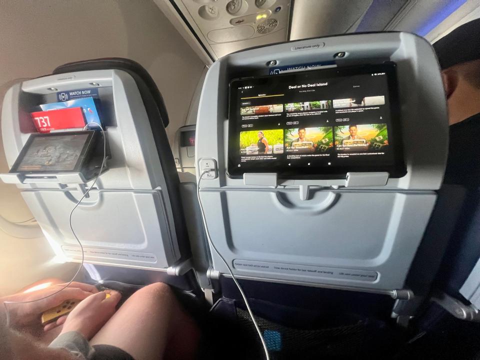 The tablet on the holder with someone playing the Switch in the seat next to the author on their's.