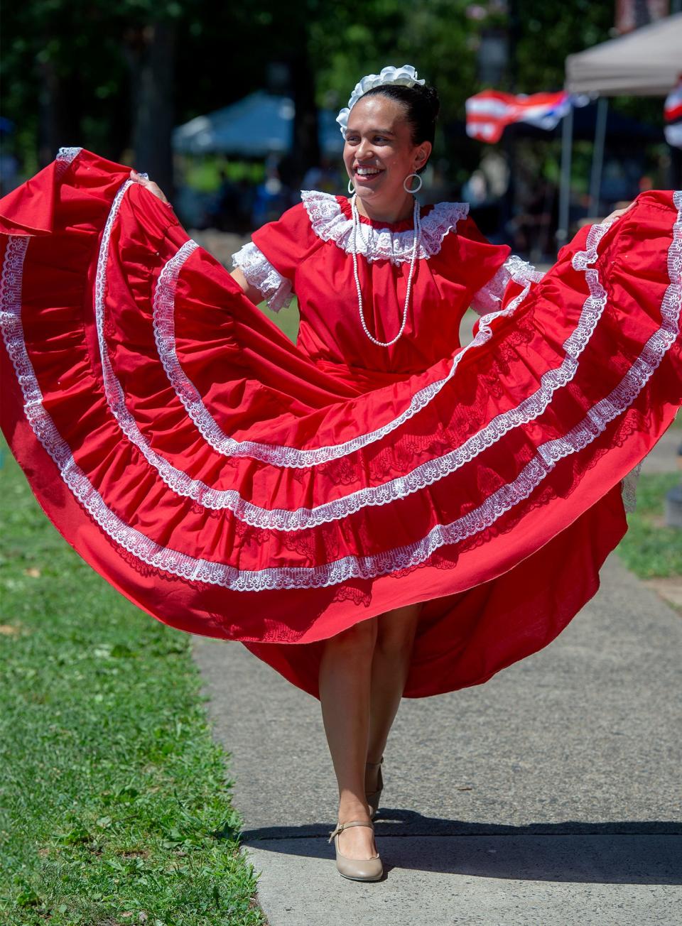Dressed in old traditional dress is Kayla Ruiz, of Bristol Borough, as she heads to the gazebo, during the 49th annual Puerto Rican Day Festival, held in Bristol Borough on Saturday, July 30, 2022.