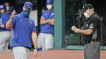 Chicago Cubs manager David Ross, left, argues with home plate umpire Tim Timmons in the fifth inning in a baseball game against the Cleveland Indians, Wednesday, Aug. 12, 2020, in Cleveland. Ross was arguing after Willson Contreras struck out. (AP Photo/Tony Dejak)