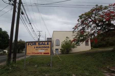 A sign offering buildings for sale is seen in a neighborhood in Christiansted, on the outskirts of St Croix, U.S. Virgin Islands June 29, 2017. REUTERS/Alvin Baez