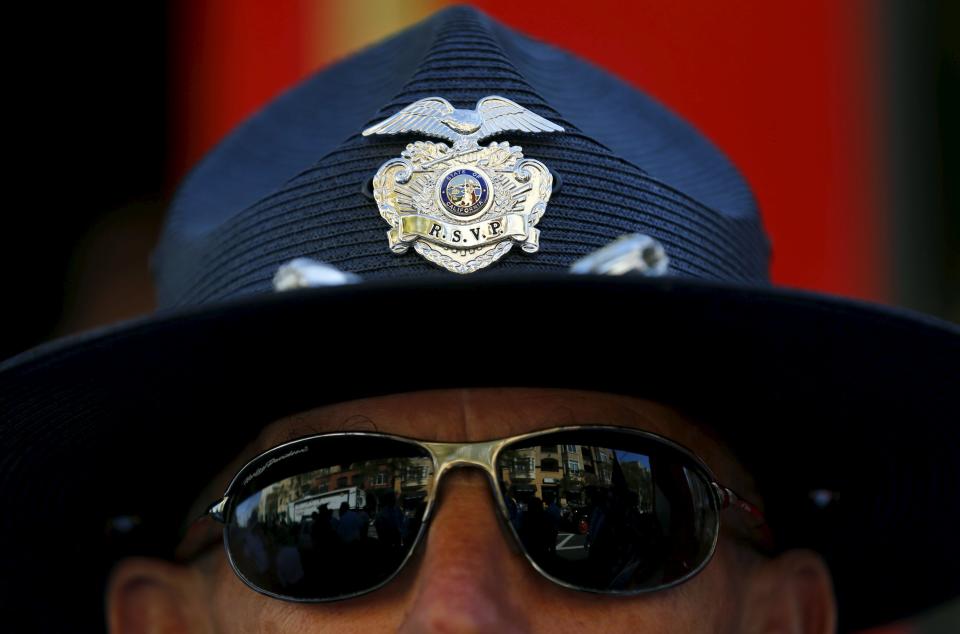 Retired Senior Volunteer Patrol member John Joyce takes part in the honour guard as he participates in the city's annual St. Patricks Day Parade in San Diego, California, United States March 14, 2015. (REUTERS/Mike Blake)
