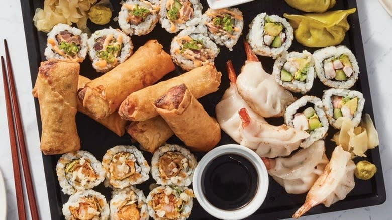 sushi, dumplings, and egg roll platter