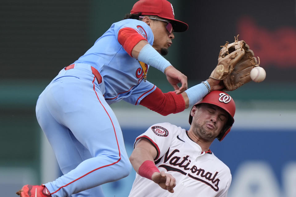 Washington Nationals' Lane Thomas, right, collides with St. Louis Cardinals shortstop Masyn Winn, left, while stealing second base during the first inning of a baseball game at Nationals Park, Saturday, July 6, 2024, in Washington. The Nationals beat the Cardinals, 14-6. (AP Photo/Mark Schiefelbein)