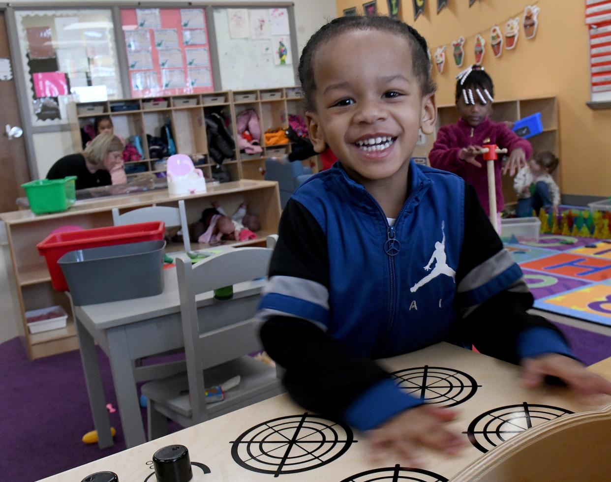 Ulysses Goard, 3, smiles wide during playtime at the JRC Learning Center on Parkway Street NW in Canton Township.