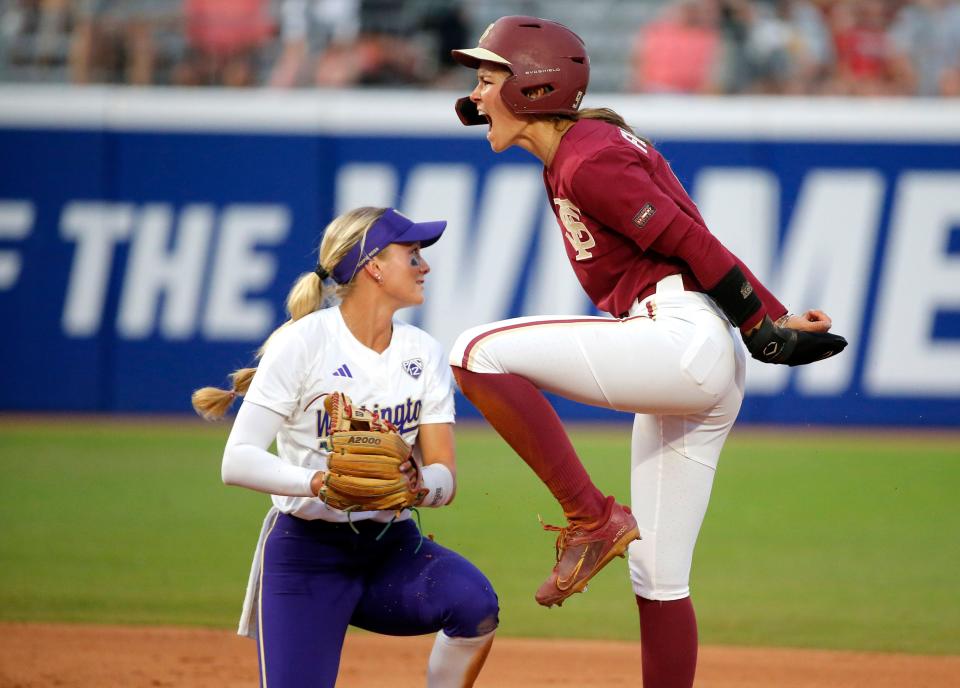 Florida State's Devyn Flaherty (9) celebrates stealing second next to Washington's Rylee Holtorf (3) in the sixth inning during a softball game between Washington and Florida State in the Women's College World Series at USA Softball Hall of Fame Stadium in  in Oklahoma City, Saturday, June, 3, 2023. 