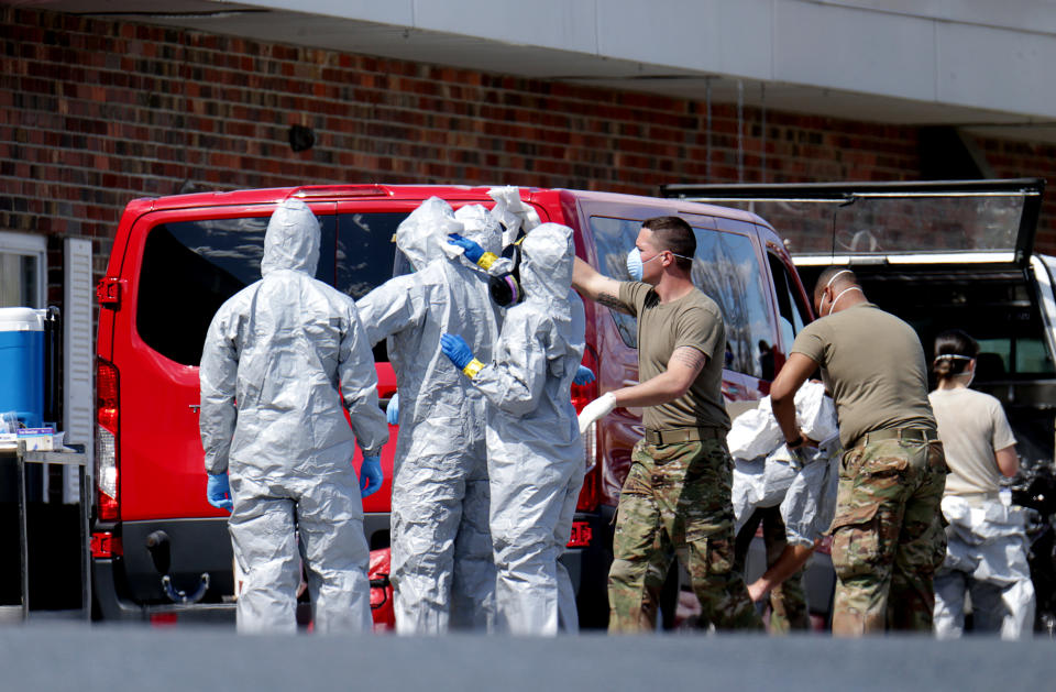 CHELMSFORD, MA - APRIL 7: Members of the Massachusetts National Guard put on hazmat suits as they are deployed to the Palm Center nursing home facility to aide in testing at the facility in Chelmsford, MA on Apr. 7, 2020. (Photo by Jonathan Wiggs/The Boston Globe via Getty Images)