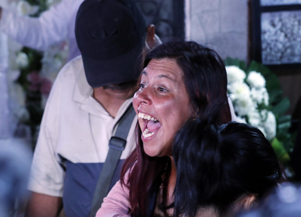 Maria Magdalena Anton, mother of Fatima, a 7-year-old girl who was abducted from the entrance of the Enrique C. Rebsamen primary school and later killed, screams "Justice" during the girl's wake at thier home in Mexico City, Monday, Feb. 17, 2020. Fatima's body was found wrapped in a bag and abandoned in a rural area on Saturday and was identified by genetic testing. (AP Photo/Marco Ugarte)