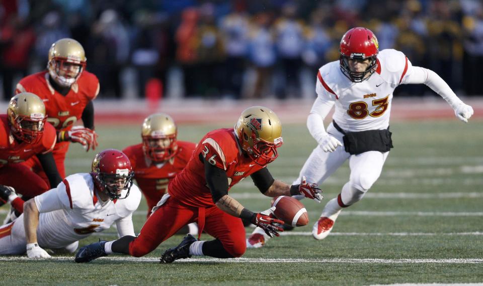 Laval Rouge et Or Vincent Plante (36) recovers the ball after a fumble by Calgary Dinos Jake Harty (6) as Dinos Brendan Thera-Plamondon (R) runs for the ball during the Vanier Cup University Championship football game in Quebec City, Quebec, November 23, 2013. REUTERS/Mathieu Belanger (CANADA - Tags: SPORT FOOTBALL)