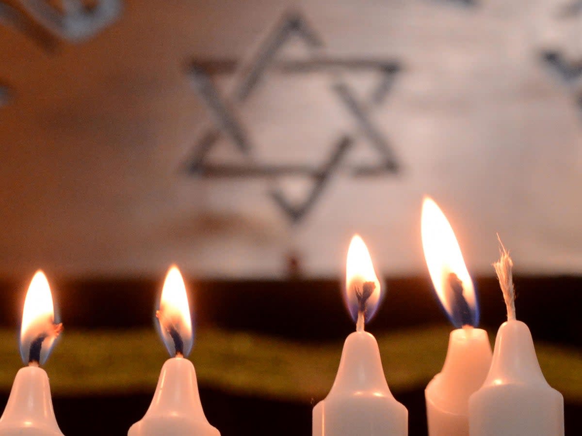 Candles are lit during the festival of Hanukkah (Getty)