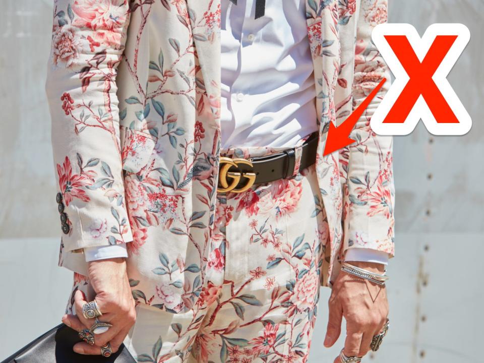 red x and arrowing pointing at a light pastel floral suit someone is wearing with a statement belt