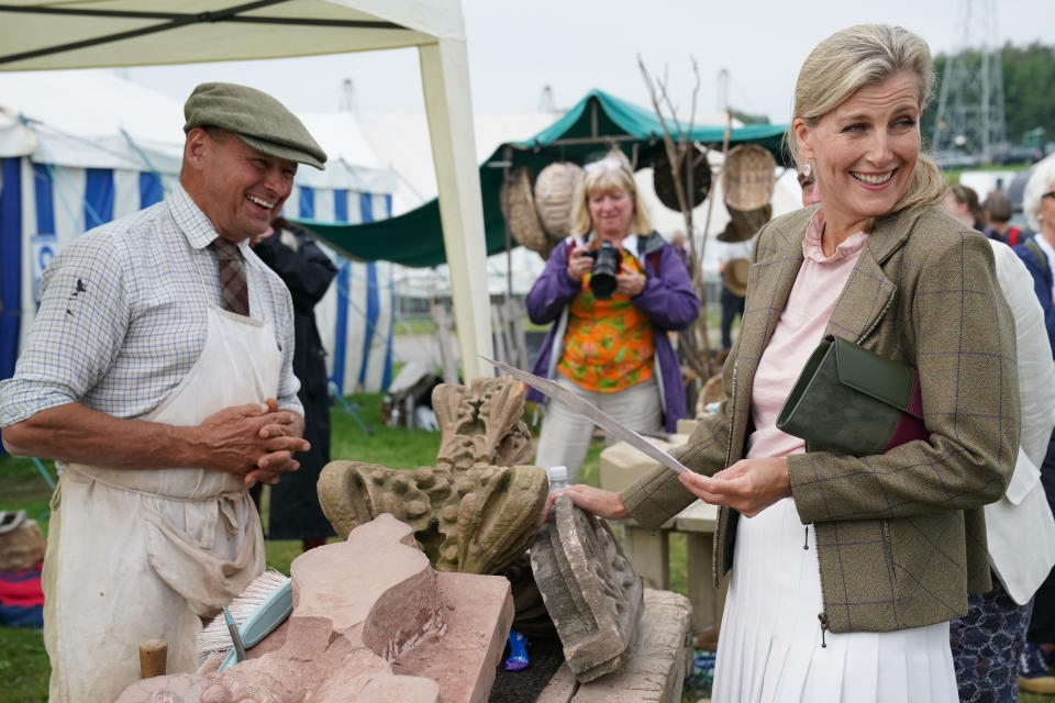 <p>The Countess of Wessex touches some stone work from the home of John Lennon, during the Westmorland County Show in Crooklands, Cumbria. Picture date: Thursday September 9, 2021.</p>
