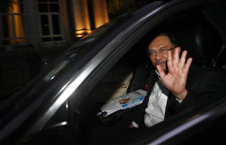 Malaysian opposition leader Anwar Ibrahim waves after walking out from a court house in Putrajaya March 7, 2014. REUTERS/Samsul Said