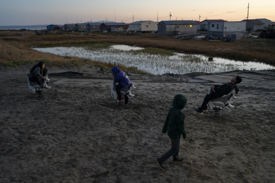 Children play in Shishmaref, Alaska, Friday, Sept. 30, 2022. Shishmaref sits on the small island of Sarichef -- just a quarter of a mile wide and about three miles long. Only about half of it is habitable, but hundreds of feet of shore have been lost in past decades. (AP Photo/Jae C. Hong)