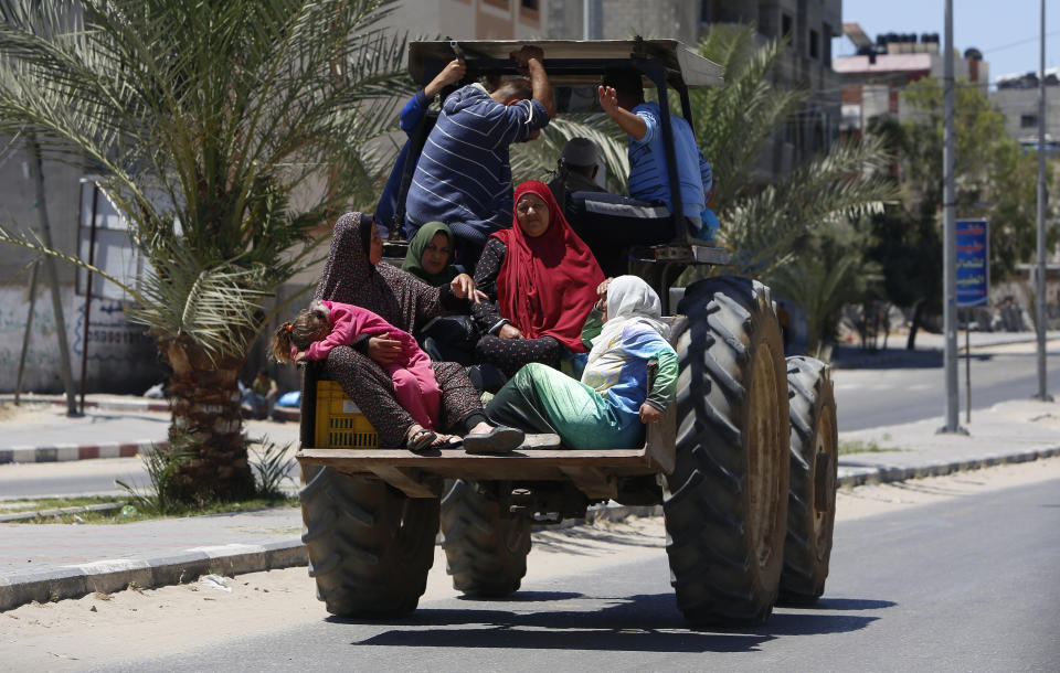 Palestinian family sit in a truck as they fleeing their house in Gaza City, Tuesday, May 18, 2021. Since the fighting began last week, the Israeli military has launched hundreds of airstrikes it says are targeting Hamas' militant infrastructure, while Palestinian militants have fired thousands of rockets into Israel. (AP Photo/Hatem Moussa)