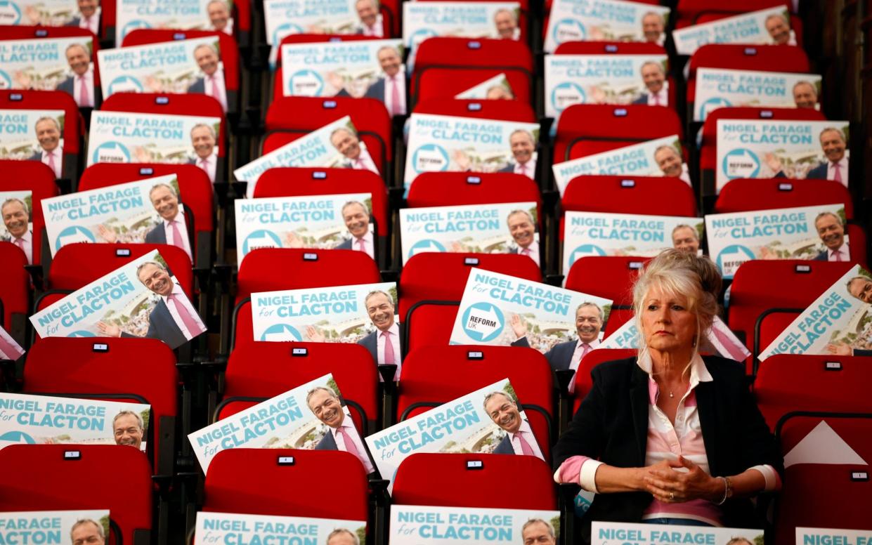 Voters wait for Reform Party Leader Nigel Farage at the Princes Theatre in Clacton on Sea in Essex