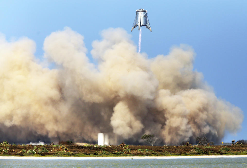 FILE - In this Tuesday, Aug. 27, 2019 file photo, SpaceX tests their StarHopper, successfully hovering 500 feet above the launch site and safely landing at the company's facility in Brownsville, Texas. (Miguel Roberts/The Brownsville Herald via AP)