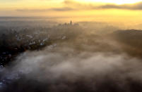 The castle of the city of Kronberg is surrounded by fog near Frankfurt, Germany, Sunday, Nov. 27, 2022. (AP Photo/Michael Probst)