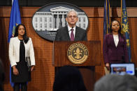 US Attorney General Merrick Garland, center, speaks during a press conference at Louisville Metro Hall in Louisville, Ky., Wednesday, March 8, 2023. The U.S. Justice Department has found Louisville police have engaged in a pattern of violating constitutional rights following an investigation prompted by the fatal police shooting of Breonna Taylor. Rear left is Associate Attorney General Vanita Gupta, and right is Assistant Attorney General Kristen Clarke. (AP Photo/Timothy D. Easley