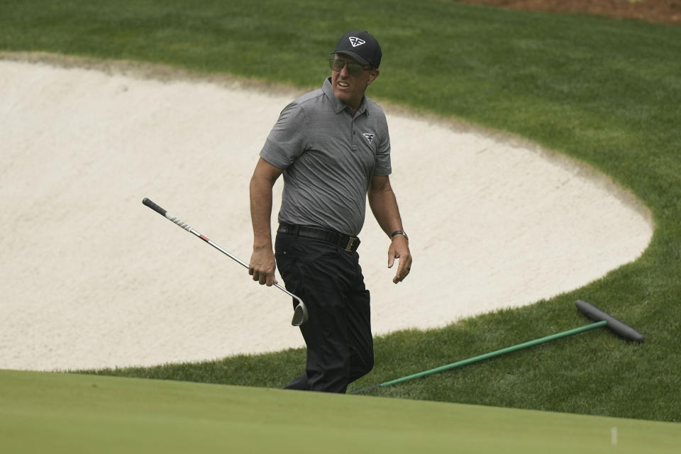 Phil Mickelson walks near the 13th green during a practice for the Masters golf tournament at Augusta National Golf Club, Tuesday, April 4, 2023, in Augusta, Ga. (AP Photo/Charlie Riedel)