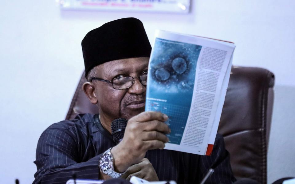 Nigeria's Minister for Health Osagie Ehanire displays an image of the the novel coronavirus COVID-19 as he address the media regarding the first case of the virus confirmed in Nigeria during a press briefing in Abuja - KOLA SULAIMON / AFP