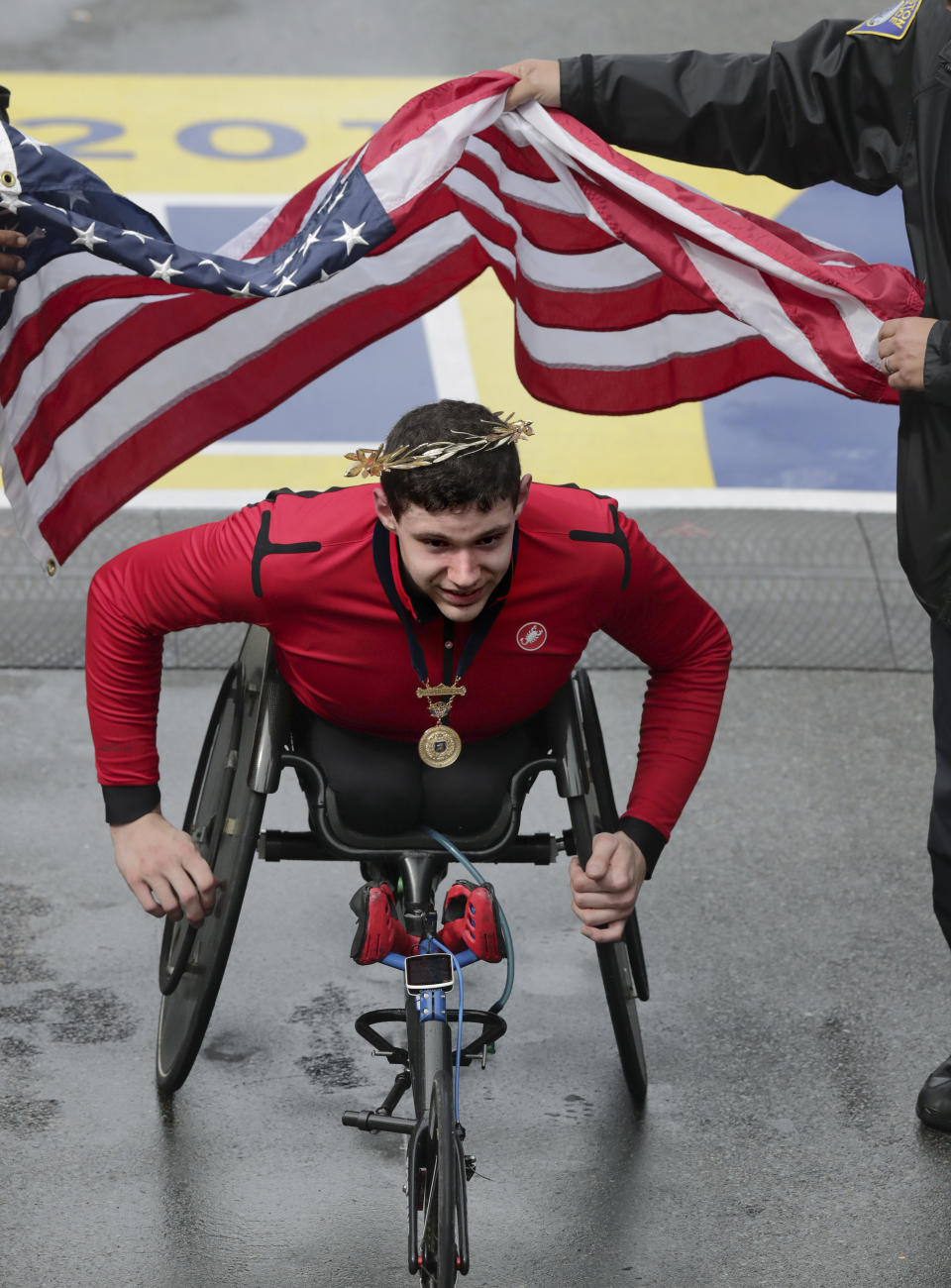Daniel Romanchuk, of Urbana, Ill., wears the victor's wreath after winning the men's handcycle division of the 123rd Boston Marathon on Monday, April 15, 2019, in Boston. (AP Photo/Charles Krupa)
