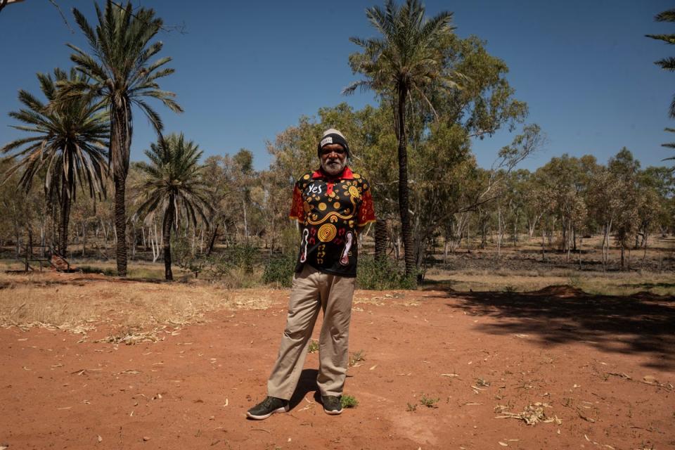 Land council worker Conrad Malcolm Ratara, 61, poses in front of the dried river bank where his ancestors lived in what is now the Hermannsburg Historic Precinct (Reuters)