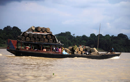 People travel on a locally built passenger boat loaded with oil containers through a creek on the River Nun in Nigeria's oil state of Bayelsa December 6, 2012. REUTERS/Akintunde Akinleye/File Photo