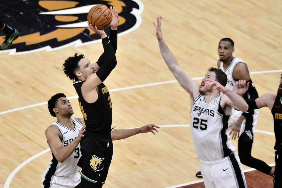 Memphis Grizzlies forward Dillon Brooks (24) shoots against San Antonio Spurs center Jakob Poeltl (25) and forward Keldon Johnson (3) during the second half of an NBA basketball Western Conference play-in game Wednesday, May 19, 2021, in Memphis, Tenn. (AP Photo/Brandon Dill)