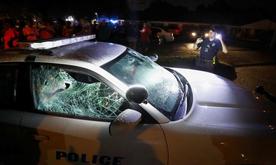 A Memphis police officer looks over a damaged squad car Wednesday in Memphis.